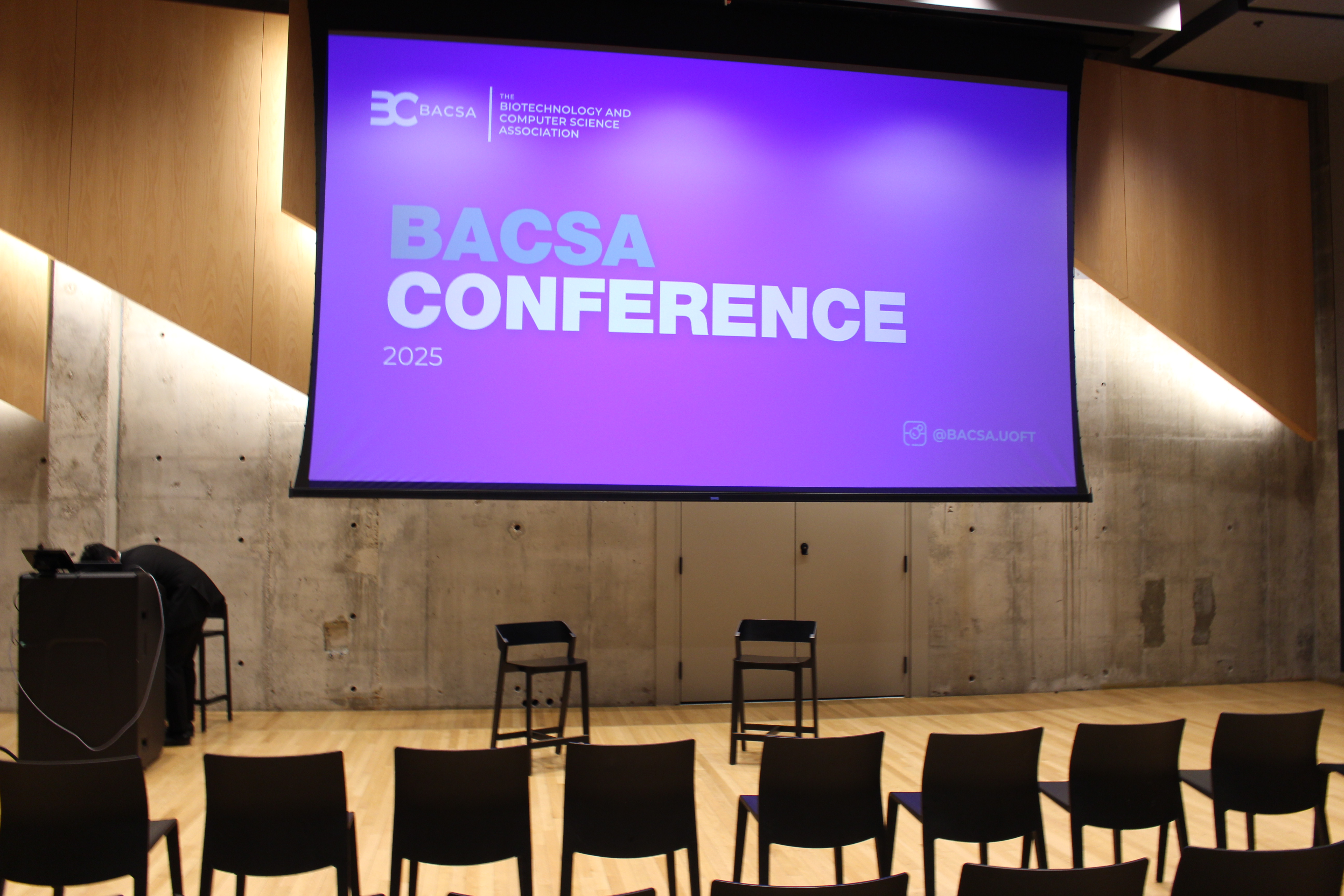 BACSA Conference 2025 presentation screen in a modern auditorium with professional setup