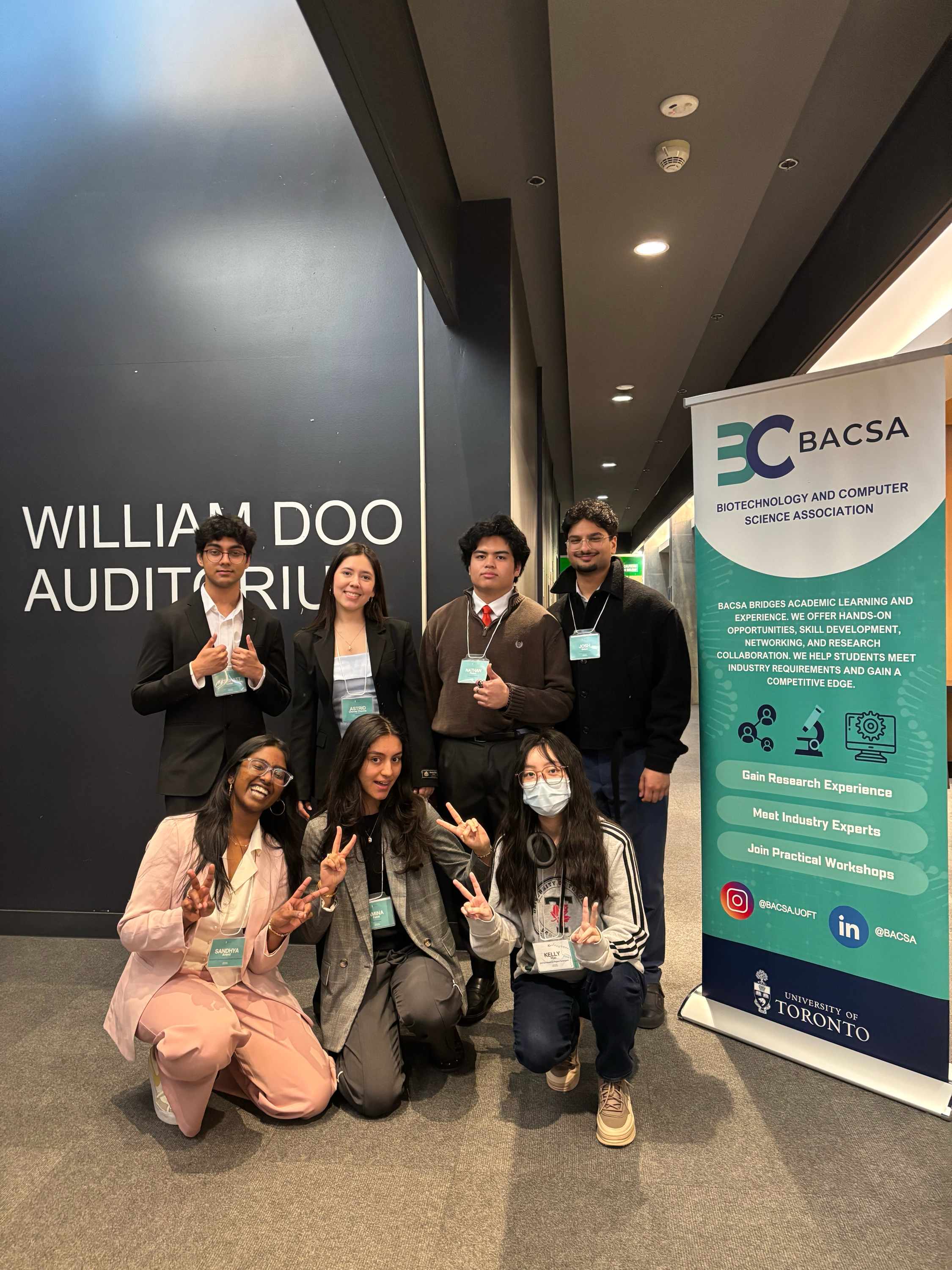 BACSA team members at a professional conference with the official BACSA banner